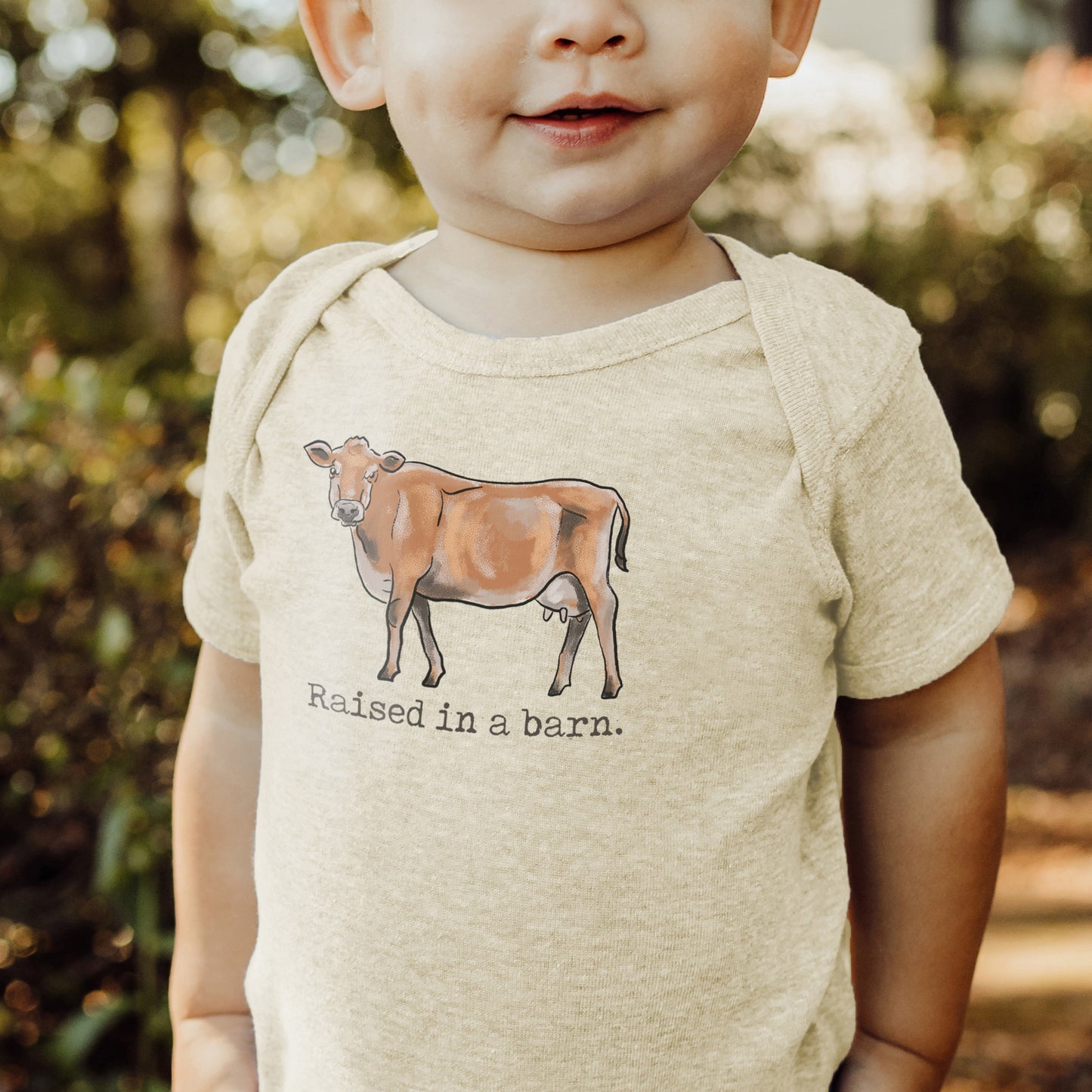 "Raised in a barn" Cow Baby Body Suit
