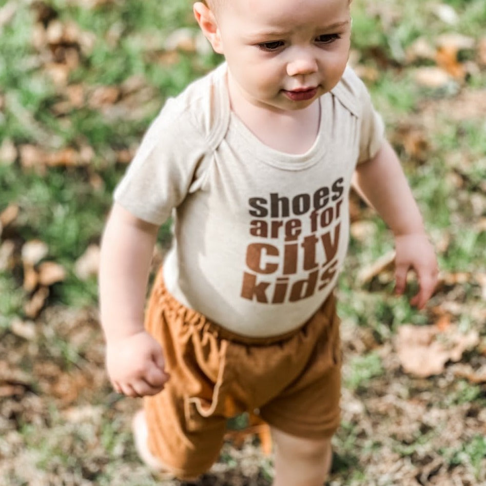 "Shoes are for city kids" Unisex Baby Body suit