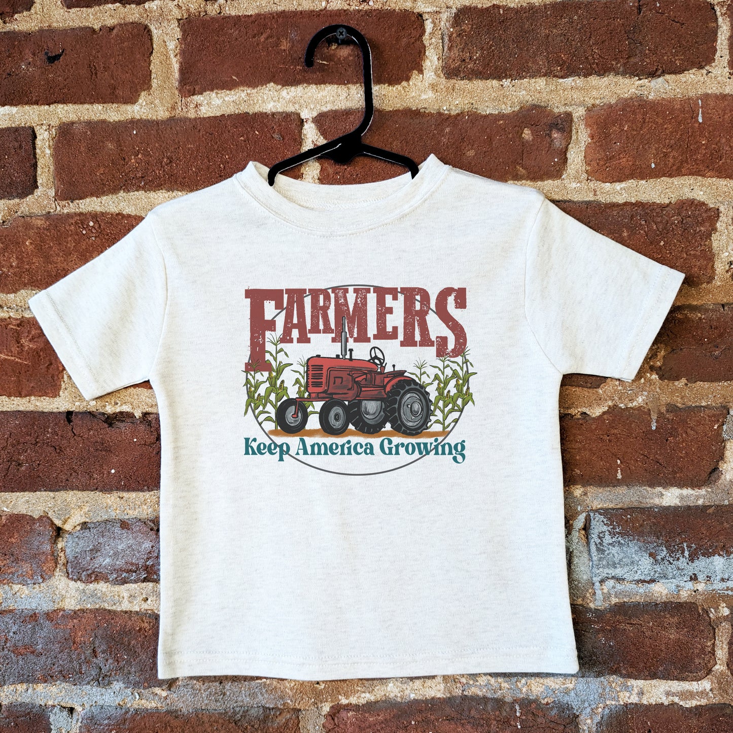 "Farmers keep America growing" Beige Toddler/Youth Tee. Red tractor