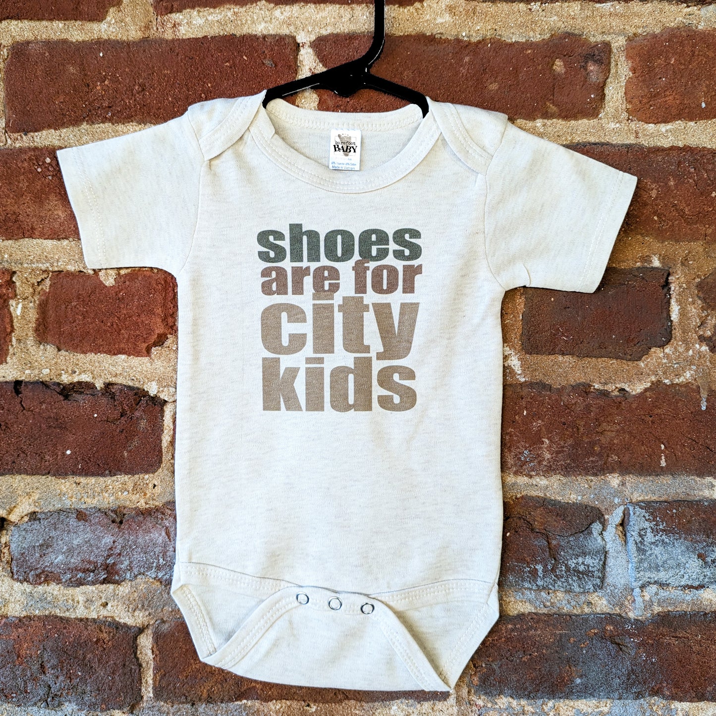 "Shoes are for city kids" Unisex Baby Body suit